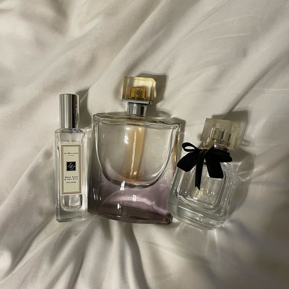 3 mostly empty bottles of perfume.
